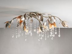 a chandelier with flowers and leaves hanging from it