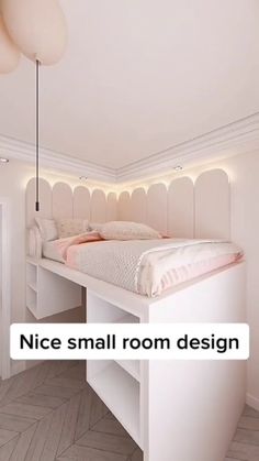 a white bed sitting under a light in a bedroom