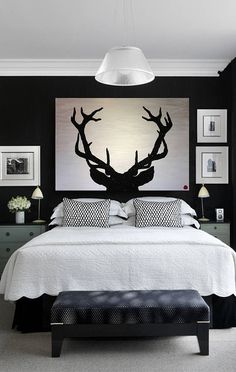 a bedroom with black walls and white bedding is featured on the instagram page