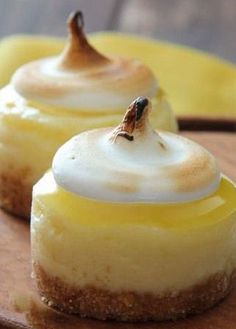 three desserts on a wooden plate with silverware