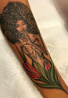 a woman with an afro on her arm is holding a flower in her right hand