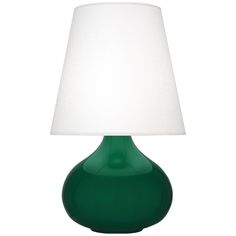 a green table lamp with a white shade on the top and bottom part of it