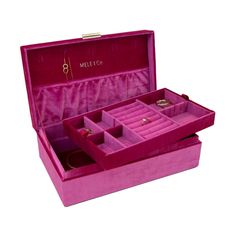 a pink velvet jewelry box with multiple compartments and gold rings in the inside, on a white background