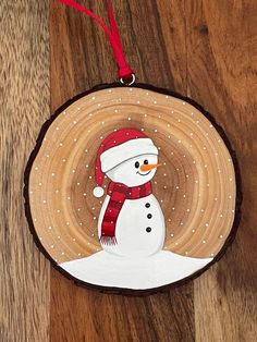 a wooden ornament with a snowman on it