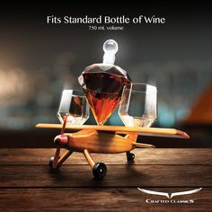 a wooden toy airplane with wine glasses on it's wheels and the words, his standard bottle of wine