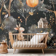 a baby's room with a wallpapered mural and a crib in the foreground