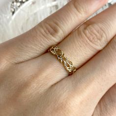 a woman's hand with a gold ring on it