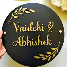 a person holding up a sign that says vaadeh and abhisek on it