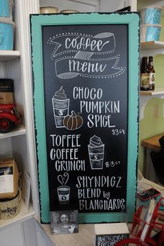 a chalkboard sign with coffee menu written on it