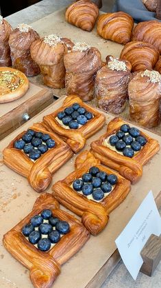 breads, pastries and blueberries are on display for sale