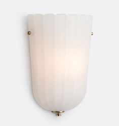 a wall light with a white glass shade