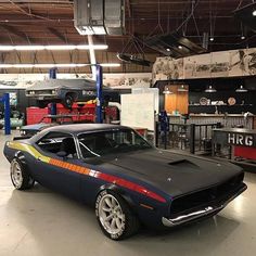 a car is parked in a garage with other cars