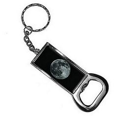 a keychain with the moon on it's front and back sides, hanging from a metal chain