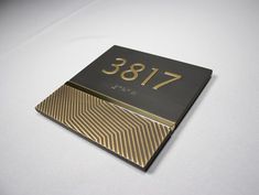 a black and gold business card sitting on top of a white table with the number 788