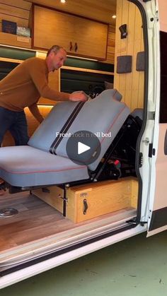 a man unloading furniture from the back of a van