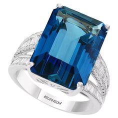 Expertly crafted in 14k white gold, this EFFY® ring features a stunning 13-1/3 ct. t.w. London Blue Topaz, accented by 3/8 ct. t.w. Sparkling diamonds. The 16.00 x 11.76 x 9.50 mm gemstone is expertly cut for maximum brilliance. Baguette diamonds of superior quality (VS clarity and F color) are set on shank sides. The center row is round brilliant diamonds. The ring shank measures 9.50 mm It is a luxurious statement piece perfect for any occasion. Effy Rings, London Blue Topaz Ring, Amethyst Color, Green Quartz, Pink Amethyst, Swiss Blue Topaz, Jewelry Repair, London Blue Topaz, London Blue