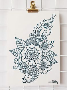 a clipboard with a drawing of flowers on it hanging on a tiled wall in a bathroom