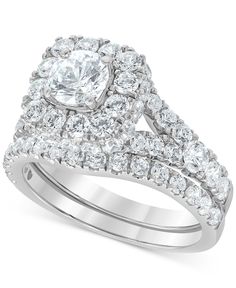 a wedding ring set with an oval cut diamond surrounded by smaller round diamonds on each band