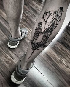 a man's leg with a black and white tattoo on it