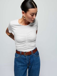 The classic crewneck tee you live in looks a little more chic now. Might be that effortlessly feminine front shirring. If we had to guess. (This one comes in White.) | Women's Alina Tee Top in White | Ethical Essentials Chic Crew Neck Tops For Casual Gatherings, Chic Relaxed Fit T-shirt For Casual Gatherings, Fitted T-shirt For Casual Gatherings, Casual Fitted Ruched T-shirt, Casual Ruched Fitted T-shirt, White Fitted Top For Casual Gatherings, Fitted White Tops For Casual, Fitted White Top For Casual Gatherings, White Fitted Effortless Tops