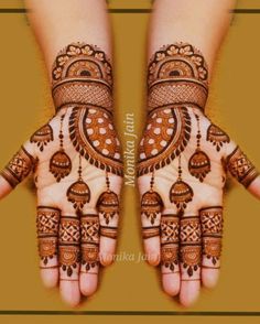 two hands with henna designs on them