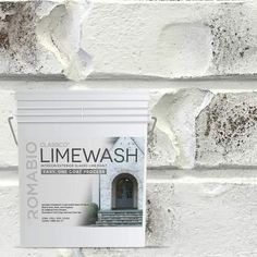 a white brick wall with a sign on it that says limewash next to the door