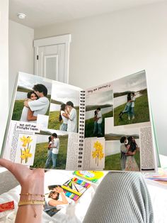 a person holding up an open book with pictures on it