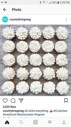 cupcakes with white frosting are arranged on a table