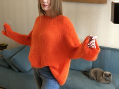 "An oversized sweater will fit sizes S-L Consisting of: 67% superkid mohair 3% wool 30% pa Color may appear slightly different on your computer monitor -One size: width - 130-134 сm/51.18\"-52.7\", Length - 60 cm/23.6\" Bright and stylish sweater made of high-quality Italian yarn. This soft body-friendly sweater will be relevant in autumn and spring, because it warms well, despite its weightlessness This round-neck sweater model looks very feminine. It has a loose fit that allows you to tuck it into jeans or wear it as an oversized pullover. The pleasant orange color will highlight your brightness and uniqueness, making your everyday life more colorful. CARE: Hand wash in cold water at 30-32C (86-89,6F) ONLY with a special detergent for wool and silk. Then spread out to dry on a horizontal Winter Mohair Knitted Tops, Winter Soft Knit Mohair Tops, Cozy Winter Mohair Tops, Long Sleeve Mohair Top For Fall, Soft Knit Mohair Crew Neck Sweater, Mohair Soft Knit Crew Neck Sweater, Mohair Crew Neck Soft Knit Sweater, Mohair Sweater With Soft Knit And Crew Neck, Soft Mohair Sweater For Winter