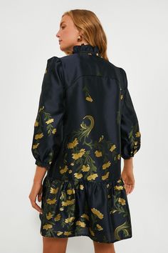 A feminine silhouette filled with movement and grace, the Navy Jasmine Vine Palmerston Dress is the dress of our dreams. A ruffled collar and long sleeves play for a sophisticated feel while the golden florals are perfect for year-round styling. Pair with heels and gold earrings for an upcoming trip, shower, or brunch! Standup ruffle collar Notched neckline Three-quarter length sleeves Drop waist Mini length A-line silhouette Lined Jacquard fabric Material: 100% Polyester (outer), 97% Polyester, Formal Long Sleeve Jacquard Dress, Long Sleeve Jacquard Evening Dresses, Elegant Jacquard Dress For Work, Fall Dresses With Ruffles And Bishop Sleeves, Chic Long Sleeve Jacquard Dress, Fitted Dress With Ruffled Collar For Fall, Fitted Fall Dresses With Ruffled Collar, Elegant Fall Dresses With Ruffled Collar, Formal Ruffled Dress With Bishop Sleeves