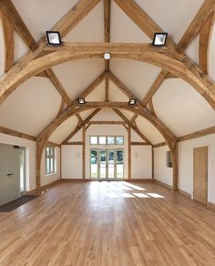 an empty room with wooden floors and beams