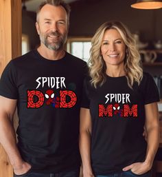 two people wearing matching spider - man shirts