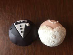 two cakes decorated to look like bride and groom's suits, one is pink and the other is black