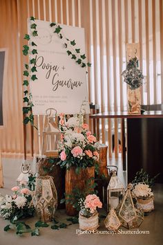 a table with flowers and candles on top of it next to a sign that says do you