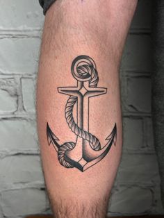 an anchor and rope tattoo on the leg