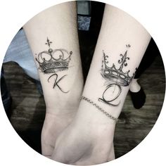 two people holding hands with tattoos on their arms and one has a crown tattooed on the wrist