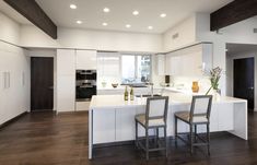 two chairs sit at the center of a kitchen island