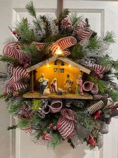 a christmas wreath with a nativity scene on it