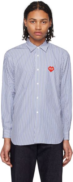 Cotton broadcloth shirt. Stripes throughout. · Spread collar · Button closure · Logo graphic appliqué at chest · Shirttail hem · Single-button barrel cuffs · Mother-of-pearl hardware Part of the Comme des Garçons Play x Invader collaboration. Supplier color: Blue/White Designer Cotton Button-up Shirt, Designer Cotton Button-up Tops, Black Casual Shirt, Striped Shirt Men, Play Comme Des Garcons, Shirt Cuff, Comme Des Garcons Play, Heart Shirt, Denim Shirt