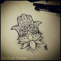 a drawing of a hamsa with a lotus flower on it