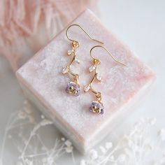 "Light Purple Flower Earrings // Gold Filled Earrings // Boho Bridal Earrings // Floral Earrings // February Birthstone // Birth Flower // Wild Flower Earrings // Birthday Gift // Gift for Mom :: Provide an enchanting effect with these fresh floral earrings :: These light purple flower earrings are a delicate and feminine design perfect for any boho wedding attire or for adding a little sparkle to your next special occasion. The tiny purple flower petals are created with faceted glass and secured to golden stems featuring small cubic zirconia leaves. The wild flower earrings are light weight and suspended from comfortable 14k gold filled earrings. Whether adding these flower earrings for a lovely touch of color and sophistication to your wedding day these will arrive suitably gift wrapped Elegant Lavender Flower Earrings For Gift, Lavender Pierced Earrings For Gift, Lavender Flower-shaped Earrings For Gifts, Elegant Lavender Earrings With Ear Wire, Elegant Lavender Flower Earrings With Ear Wire, Delicate Purple Earrings For Wedding, Elegant Crystal Earrings With Flower Charm Gift, Elegant Crystal Earrings With Flower Charm, Elegant Lavender Flower Shaped Jewelry