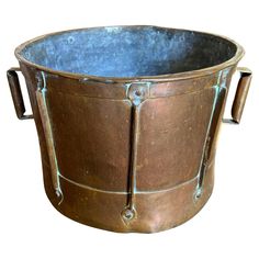 an old metal bucket with handles is shown