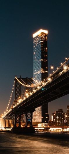 the city lights shine brightly on the bridge