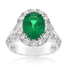 18K white gold emerald and diamond ring from the Reis Nichols Collection. The ring features one oval emerald weighing 3.00 cts. The ring also features 40 round brilliant cut diamonds, two half moon diamonds, and 12 baguette diamonds weighing 2.50 ctw. Size 6.5 in stock now. Special order sizes available. Pricing may vary with size. Classic Green Diamond Ring With Baguette Diamonds, White Gold Emerald Ring With Baguette Diamonds, Formal Green Diamond Ring With Baguette Diamonds, Oval Emerald Ring With Pave Setting In Platinum, Emerald And Diamond Ring, Emerald Diamond Ring, Baguette Diamonds, Baguette Diamond, Emerald Diamond