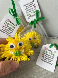 someone is holding some fake yellow flowers with googly eyes