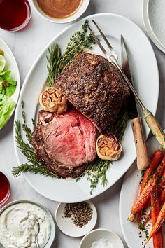 a roast beef on a plate with herbs