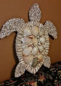 a sea turtle made out of seashells and shells