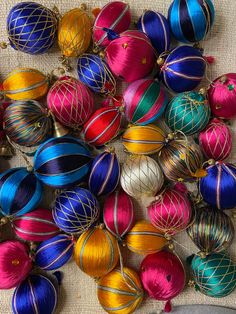 a pile of colorful ornaments sitting on top of a table