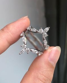 a person is holding a ring in their hand with diamonds on the inside of it