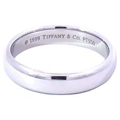 Authentic Tiffany & Co. half round classic wedding band. This band is beautifully crafted in platinum 950 with a high polish finish. The band is 4.5 mm wide. The band is hallmarked "©1999 Tiffany &Co." and stamped "PT950" on the inside. This is a pre-owned Tiffany band in excellent condition. The band is size 9, total weight is 9.7 grams. Retail price is $1850. Item Specifications: Brand: Tiffany & Co. Model: Classic Wedding Band Metal: Platinum Metal Purity: 950 Ring Width: 4.5 mm Ring Thicknes Pearl Ring Tiffany & Co., Wedding Rings Tiffany, Tiffany Ring Box, Tiffany Ribbon Ring Engagement, Tiffany Band, Tiffany Engagement Ring Tiffany & Co. Tiffany & Co., Tiffany And Co 1837 Ring, Classic Wedding Band, Band Metal